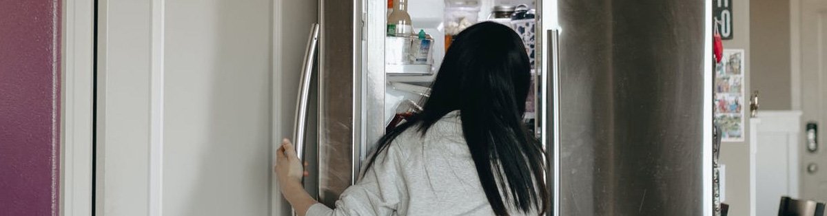 Person monitoring the temperature of his refrigerator