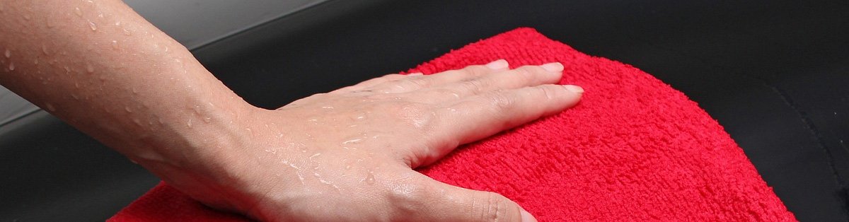 Hand Wiping Down Fridge Surface with Towel
